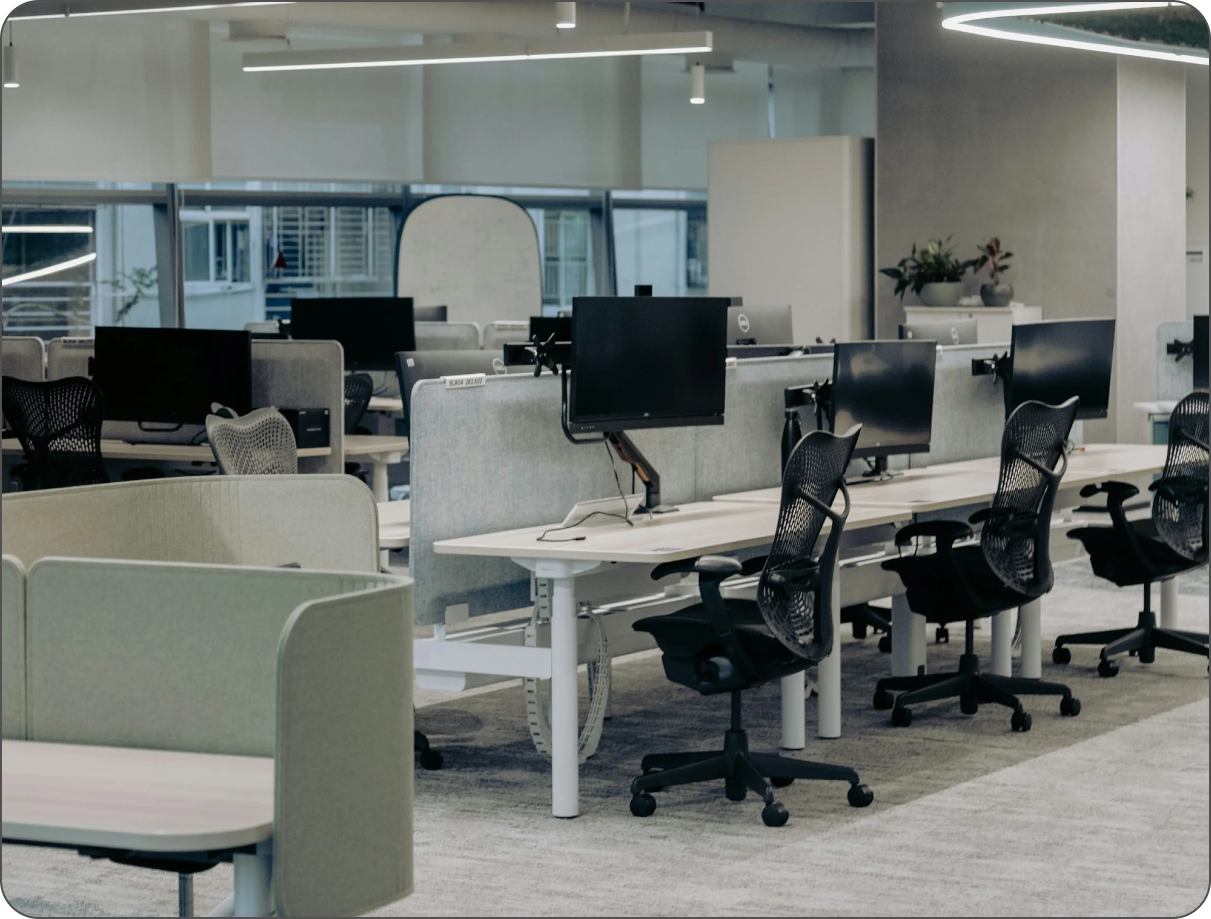 Modern office workspace at Quixify Media, showcasing ergonomic chairs and computer desks in a clean, professional digital marketing environment.
